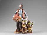 figurine of a woman with a basket of flowers and a dog