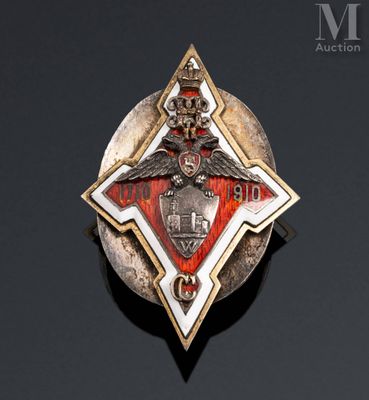 an image of a silver and red broochle with a bird on it