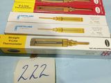 four different pens and a pen that are on a table