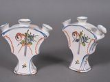 two vases that have been painted with flowers on them