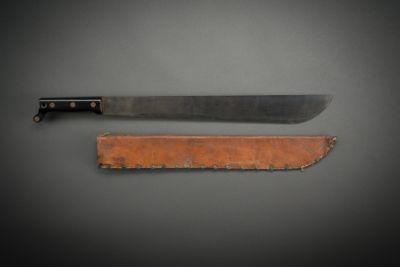 a knife that is sitting next to a piece of wood