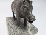 a statue of a boar on a marble base