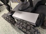 a laptop sitting on top of a motorcycle tire