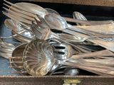 many silver spoons and spoon spoons in a box