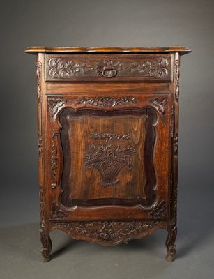 an old wooden cabinet with a carved design on the front