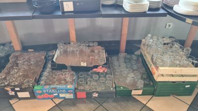 many empty glasses on a table in a store