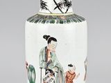 a white vase with a picture of a woman sitting on a chair