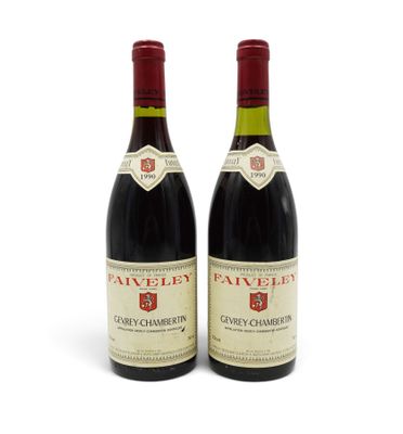 two bottles of wine sitting next to each other on a white surface