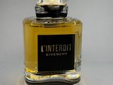 an image of a bottle of l ' interdit givenchy on a table