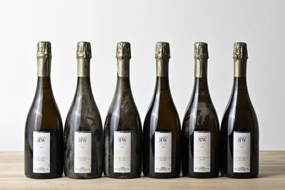 six bottles of wine are lined up on a wooden table