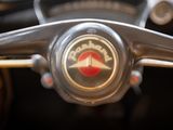 a close up of a steering wheel with a logo on it
