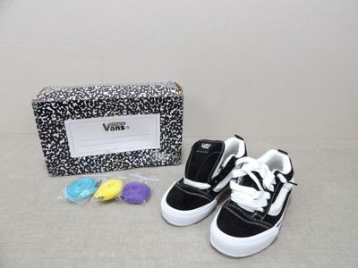 a pair of black and white shoes next to a black and white purse