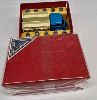 a red box with a toy truck inside of it