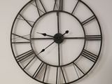a large clock that is on the wall in the room
