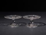 pair of clear glass wine glasses on a black surface