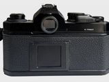 a black camera that is sitting on a white surface