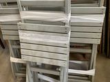 a lot of chairs that are stacked on top of each other