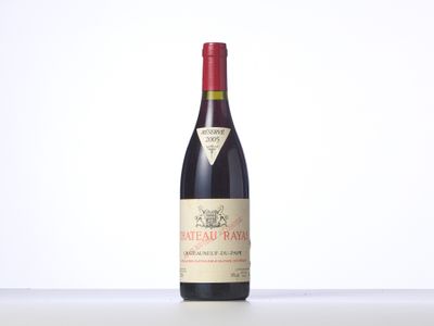a bottle of red wine sitting on top of a table