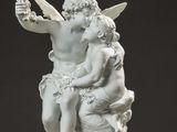 an image of a statue of two angels sitting on a rock