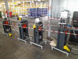 many machines that are in a warehouse with red and white tape