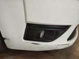 a close up of a car ' s front bumper with a denting on it