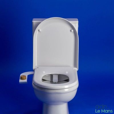 a white toilet with the lid up against a blue background