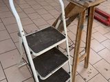 a ladder that is sitting in the middle of a room