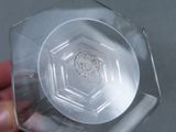 someone is holding a clear plastic container with a coin inside of it
