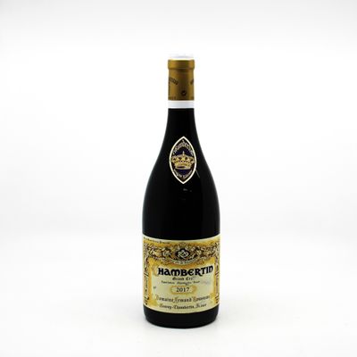 a bottle of wine sitting on top of a white table