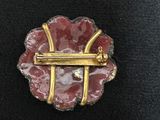 pink and gold broochi with a gold bar in the middle