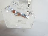 a clear glass vase with a clock on top of it