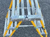 a yellow ladder that is sitting on the ground