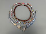 a close up of a necklace and bracelet on a table