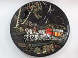 a black plate with a picture of a train on it
