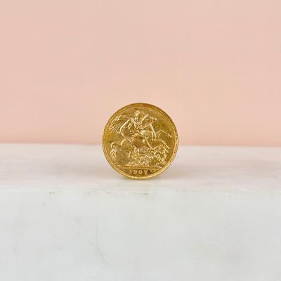 a gold coin sitting on top of a marble counter