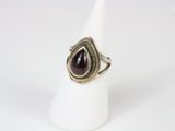 a close up of a ring with a tear shaped stone on it