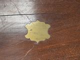 a wooden table with a yellow flower on top of it