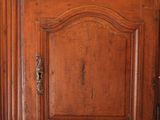 a wooden cabinet with a clock on top of it