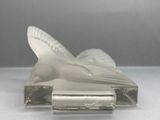 a glass sculpture of a bird that is sitting on top of a piece of glass