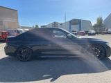 an image of a black bmw car parked in a parking lot