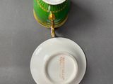 a cup and saucer sitting on a table