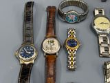 a lot of watches that are sitting on a table