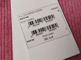 two tags on a pink cloth with a barcode on them