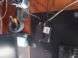 a desk with a computer, keyboard, mouse, and other items on it