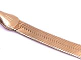 a gold bracelet with a metal clasp on a white surface