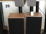 two speakers sitting on top of each other in front of boxes