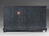 an old black wooden cabinet with two doors and a brown handle