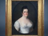 a painting of a woman in a white dress in a gold frame