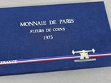 a close up of a blue book with a red, white and blue ribbon