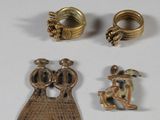 three gold rings and a ring with a bird on top of it